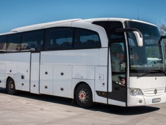 a white bus parked on concrete