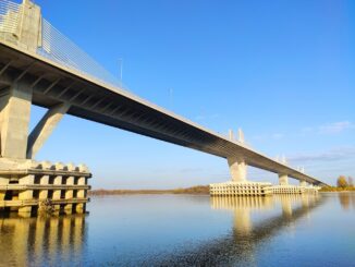 a bridge over water with blue sky , dunav most 2