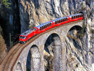 a red train on a bridge