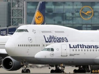 a group of airplanes parked in front of a building