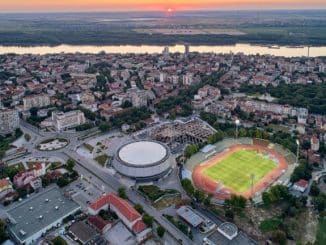 a city with a stadium and a river