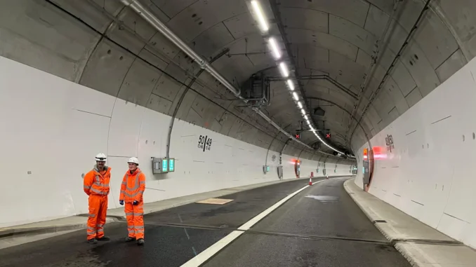 a group of men in orange uniforms in a tunnel