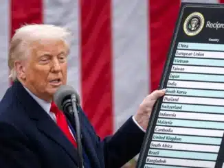 Trump holding a sign