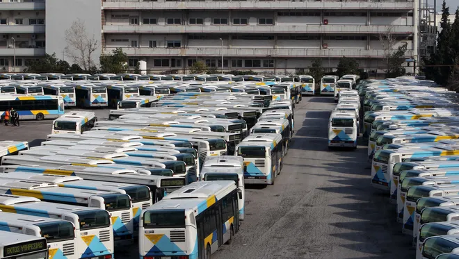 a group of buses parked in a parking lot