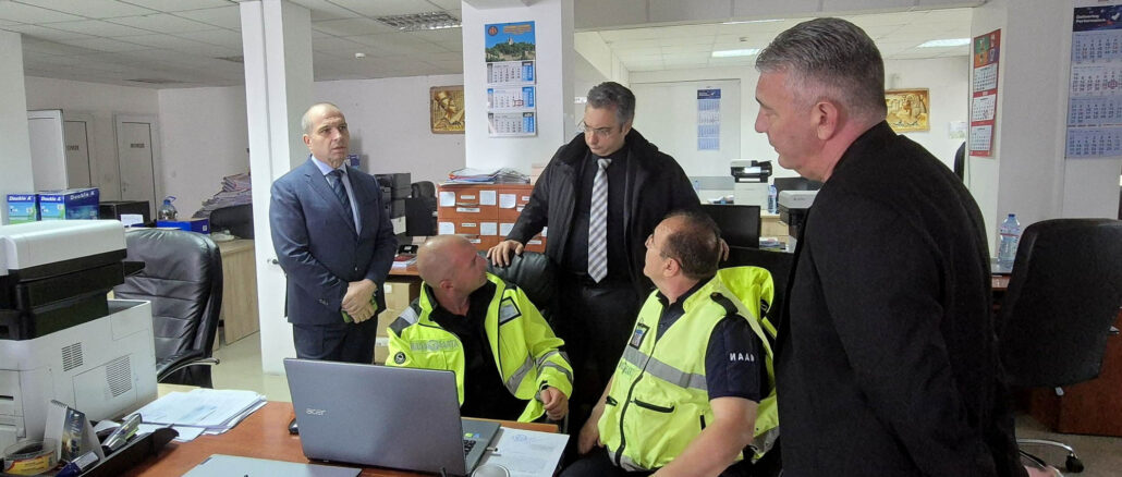 a group of men in yellow jackets in an office