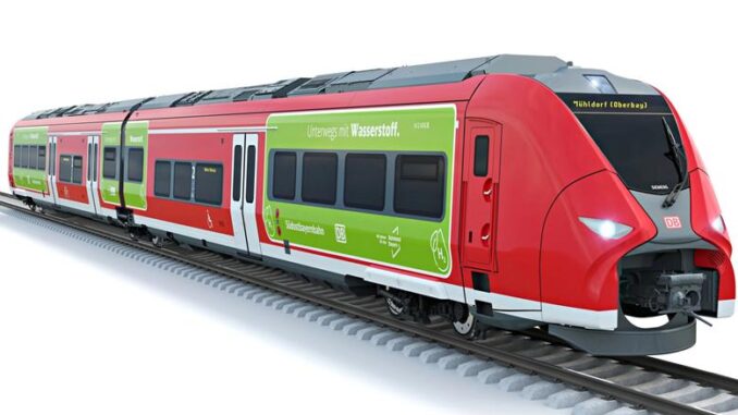 a red and green train on tracks