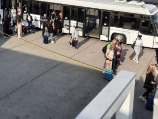 a group of people boarding a bus